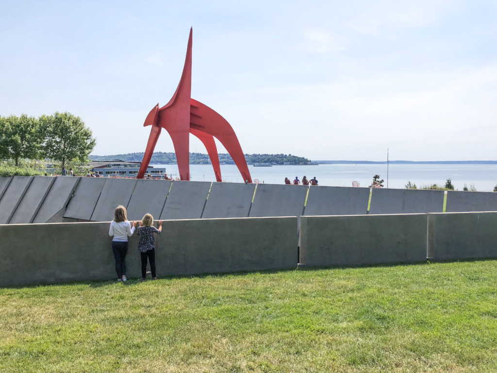 Girls standing and looking towards Puget Sound at the Olympic Sculpture Garden in Seattle
