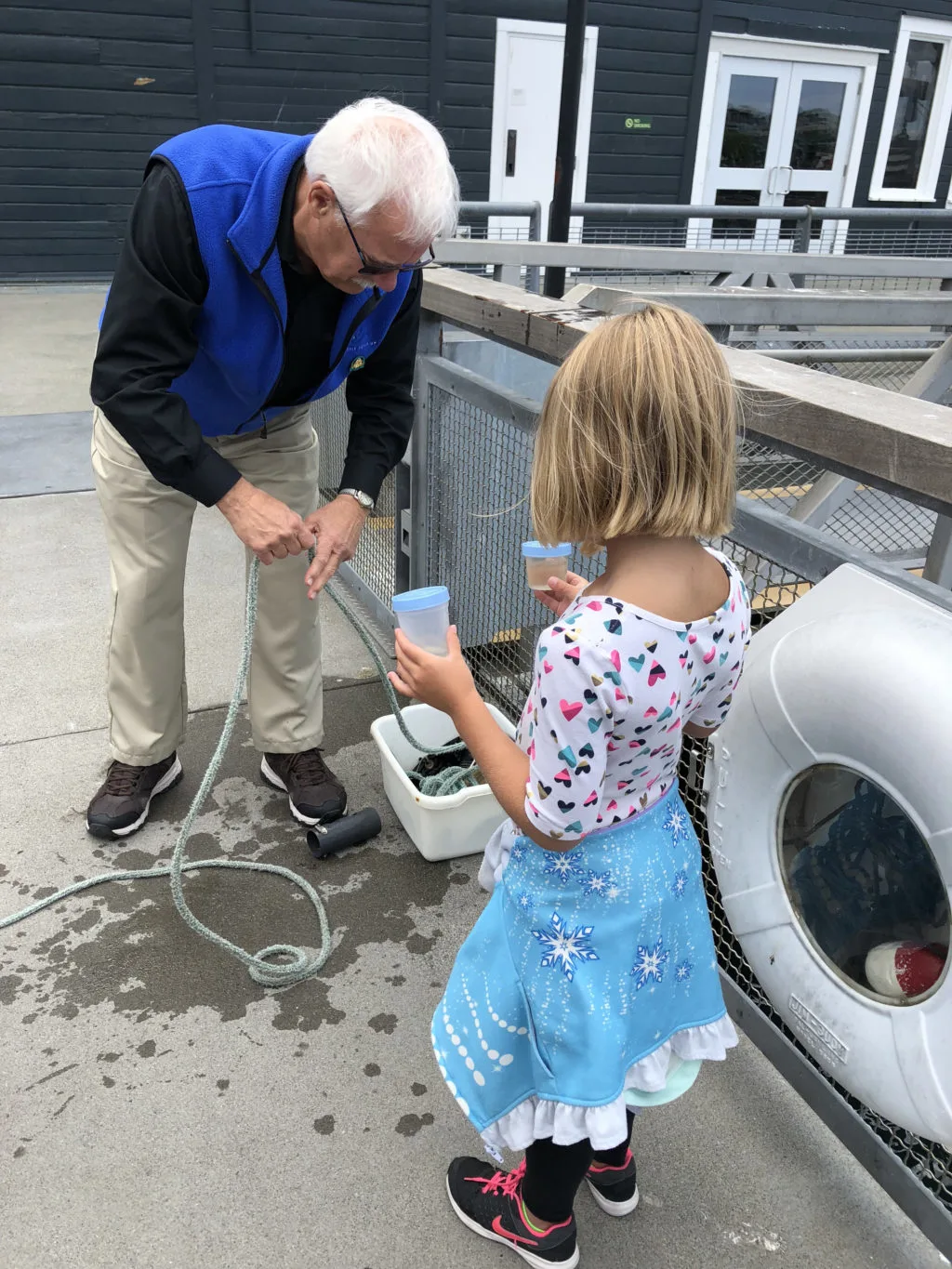 Young girl helping marine biologist from the Seattle Aquarium