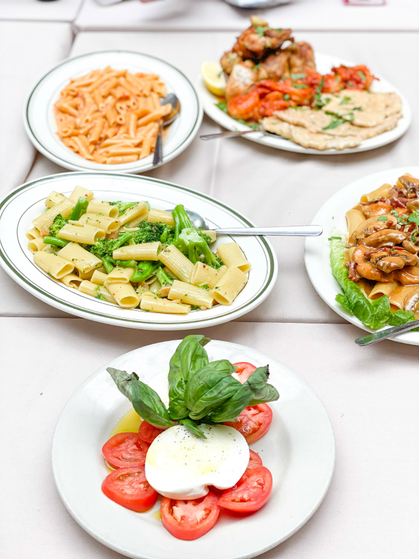 Caprese salad, penne vodka, and other plated Italian dishes