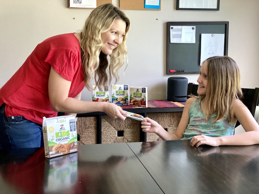 mom giving daughter snack while schooling at home