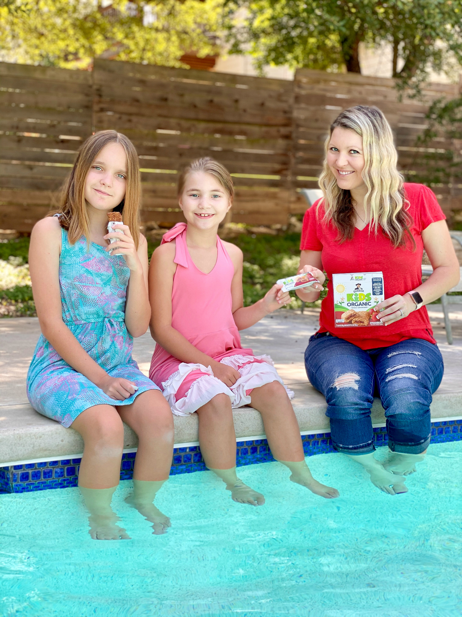 mom and girls having easy snacks by the pool