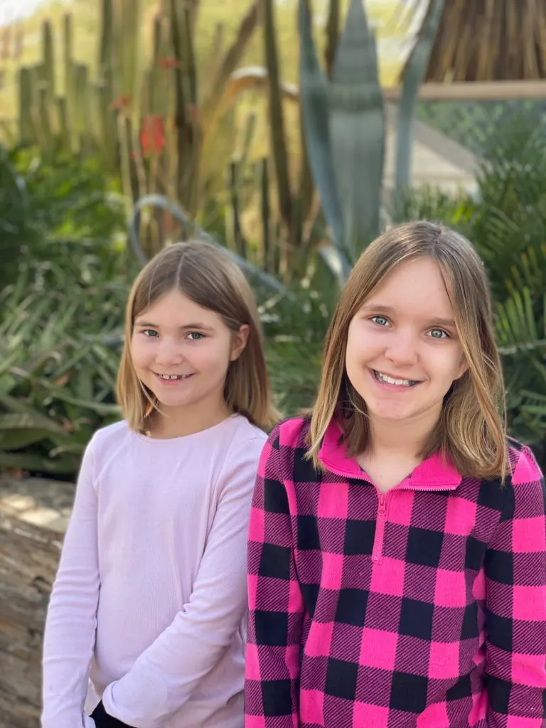 Beautiful sisters in cactus garden.