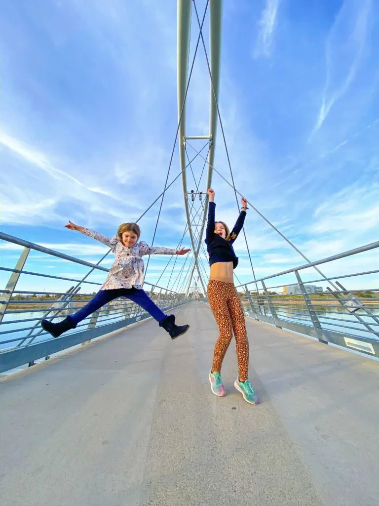 Girls Jumping on Bridge over Town Lake in Tempe Arizona