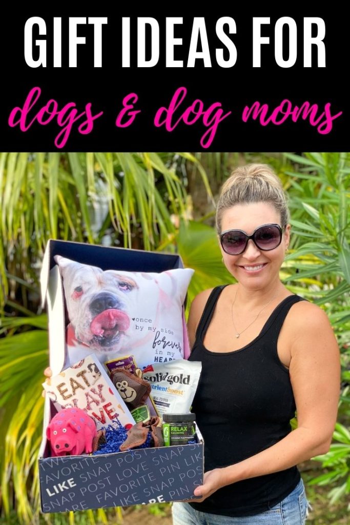 woman holding box of dog themed items with gifts ideas for dogs and dog mom text overlay