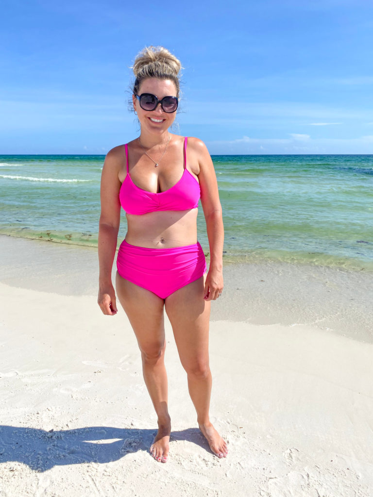 Woman on beach with after results from front Coolsculpting love handles
