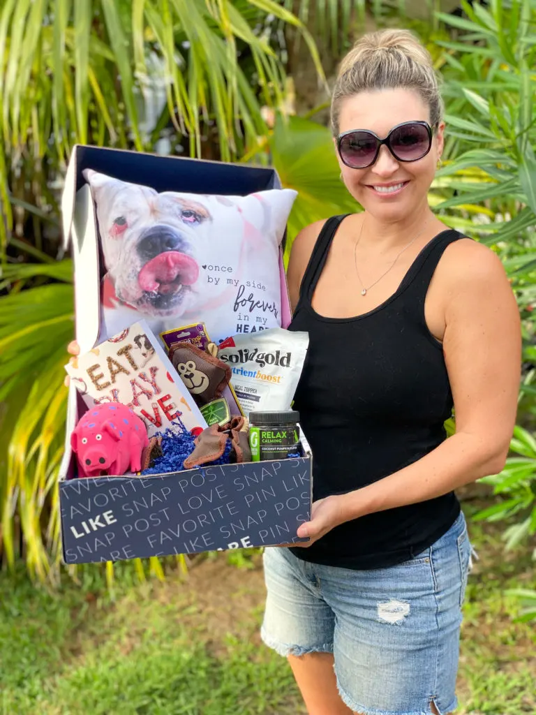 woman holding box with gift ideas for dogs and dog moms
